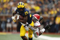 Michigan running back Hassan Haskins (25) tries to break the tackle of Rutgers linebacker Drew Singleton (11) in the first half of an NCAA college football game in Ann Arbor, Mich., Saturday, Sept. 28, 2019. (AP Photo/Paul Sancya)