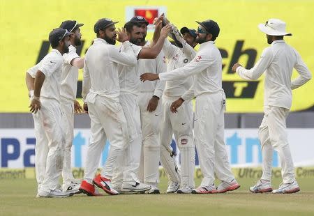 Cricket - India v New Zealand - Second Test cricket match - Eden Gardens, Kolkata, India - 03/10/2016. India's Mohammed Shami (4th L) is congratulated by his teammates after taking the wicket of New Zealand's Bradley-John Watling. REUTERS/Rupak De Chowdhuri