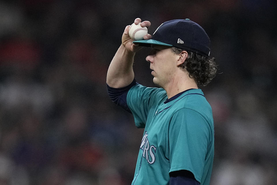 Seattle Mariners starting pitcher Logan Gilbert adjusts his cap during the eighth inning of a baseball game against the Houston Astros, Saturday, May 4, 2024, in Houston. (AP Photo/Kevin M. Cox)