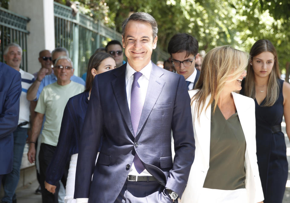 Greek opposition New Democracy conservative party leader Kyriakos Mitsotakis centre, walks with his wife Mareva, right in Athens, Monday, July 8, 2019. Mitsotakis was to be sworn in as Greece's new prime minister after a resounding win over left-wing Alexis Tsipras, who led the country through the tumultuous final years of its international bailouts. Mitsotakis' New Democracy party won 39.8% of the vote, giving him 158 seats in the 300-member parliament, a comfortable governing majority. (AP Photo/Thanassis Stavrakis)