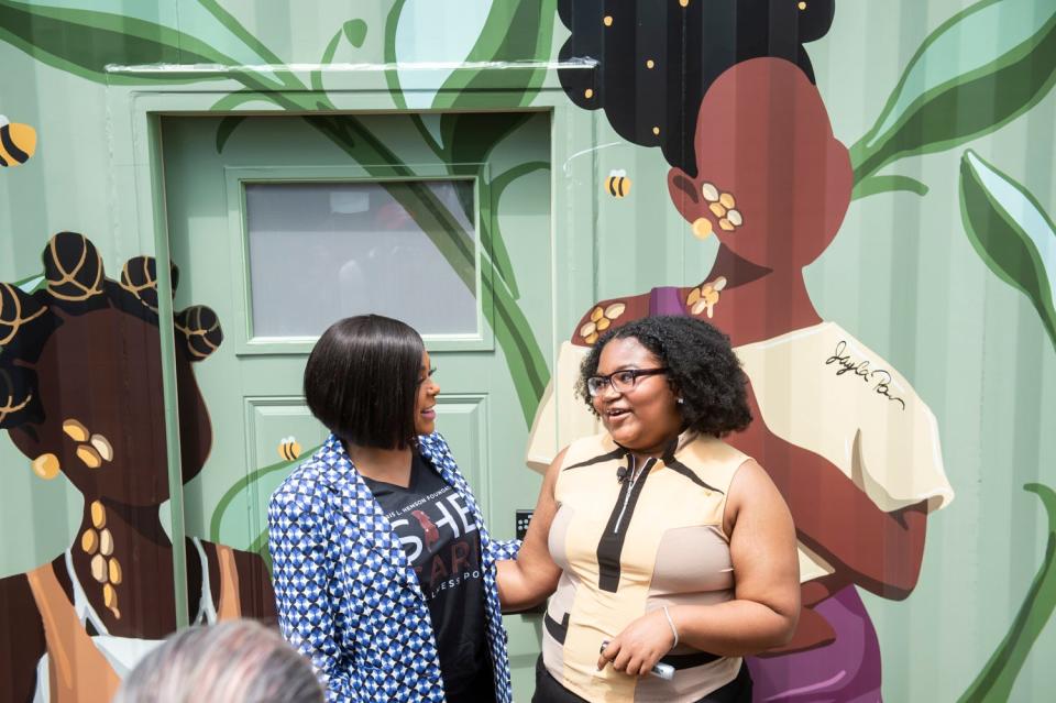 Actor Taraji P. Henson talks with mural artist Jayla Poe during the opening Friday of the She Care Wellness Pods on the campus of Alabama State University.