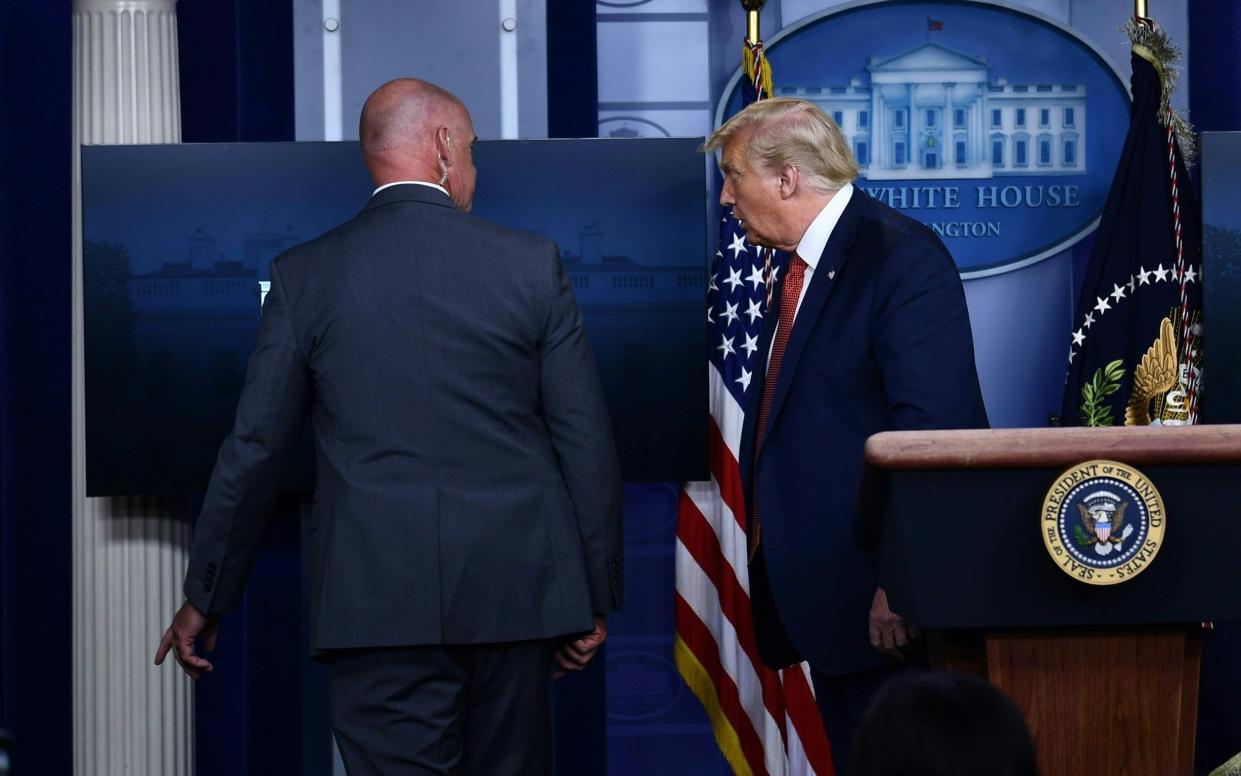Donald Trump was being removed by a member of the secret service - AFP
