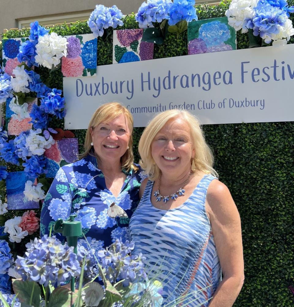 Andrea Brandeis, left, and Laura Smith, co-chairs of the Duxbury Hydrangea Festival, in front of their Insta Wall designed in partnership with the Duxbury Student Union.