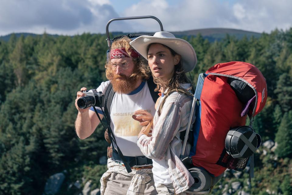 Kristofer Hivju and Hannah playing hikers with trees in the background