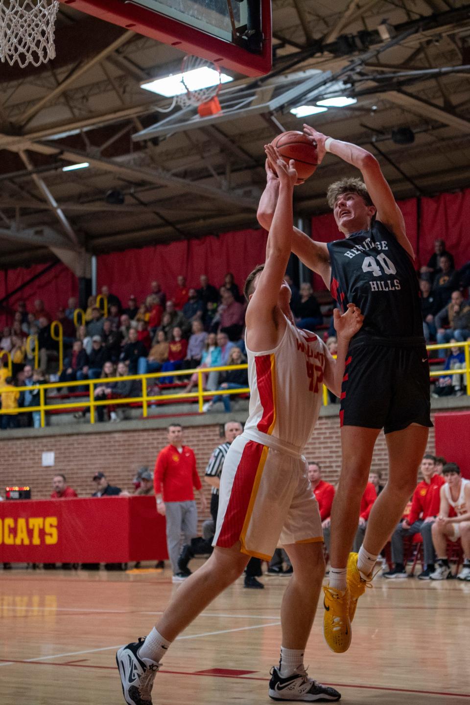 Heritage Hills’ Trent Sisley (40) takes a shot against Mater Dei’s Mason Wunderlich (42) as the Mater Dei Wildcats play the Heritage Hills Patriots Friday, Jan. 27, 2023. 