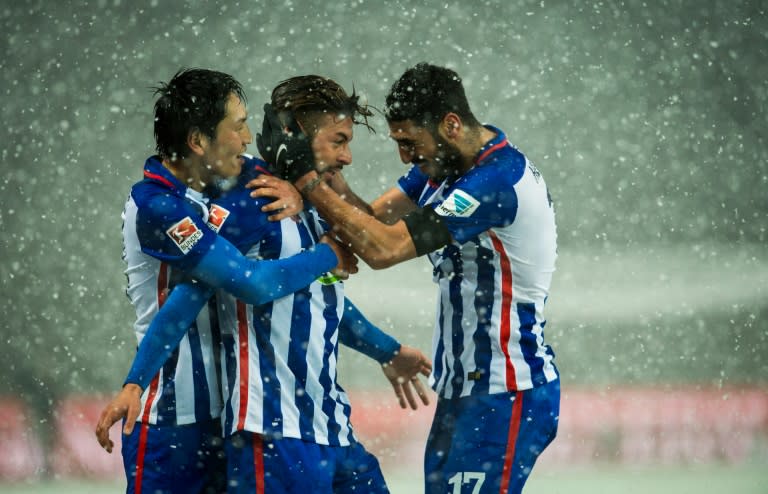 (From L) Hertha Berlin's Genki Haraguchi, Marvin Plattenhardt and Tolga Cigerci celebrate scoring a goal during their German first division Bundesliga match against Hoffenheim, at the Olympic Stadium in Berlin, on November 22, 2015