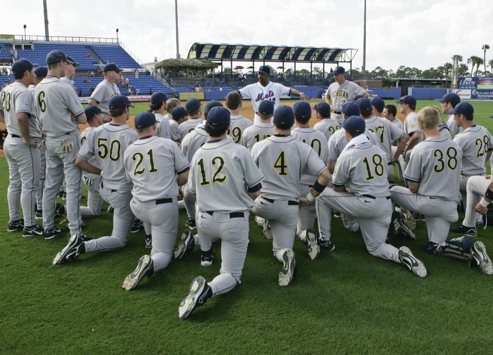 FILE - This file photo from Feb. 26, 2008, shows New York Mets manager Willie Randolph, center rear, addressing Michigan's NCAA college baseball players with Michigan's head coach Rich Maloney (2), following a baseball spring training game, in Port St. Lucie, Fla. Major League Baseball might provide scholarships and exert greater influence over Division I college baseball if a proposed partnership with the NCAA becomes reality. A spokesman for MLB, the head of the players union and the NCAA confirmed preliminary discussions have been held, most recently last month in New York. (AP Photo/Nati Harnik, File)