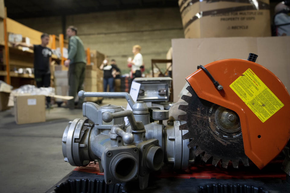 Volunteers with Razom for Ukraine, a New York-based nonprofit, pack firefighting and medical donations for shipment to Ukraine, Wednesday, Feb. 8, 2023, in Woodbridge Township, N.J. (AP Photo/John Minchillo)