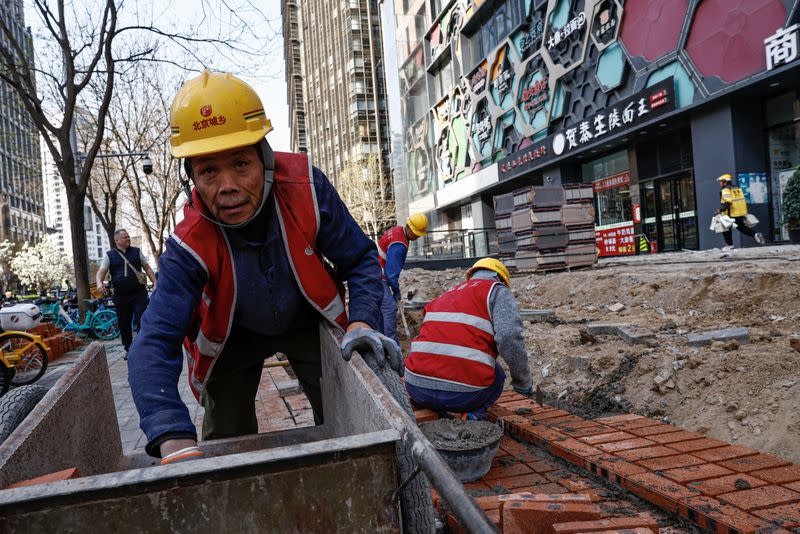 Worker labours at a construction site in Beijing