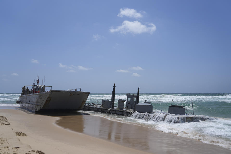 A washed up US Army vessel and a strip of docking area stranded off the coast near Ashdod, Israel, Saturday, May 25, 2024. A small US military boat and what appeared to be a strip of docking area washed up on a beach near the southern Israeli city of Ashdod. (AP Photo/Tsafrir Abayov)