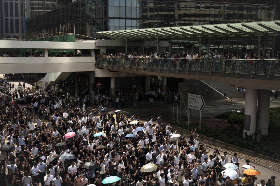 Anti-government protesters march at Central district in Hong Kong, Wednesday, Oct. 2, 2019. Thousands marched in the business district denouncing police shooting of a teenage protester during widespread anti-government demonstrations that marred China's National Day. (AP Photo/Felipe Dana)