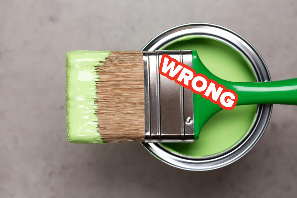 paint brush resting on top of a can of paint