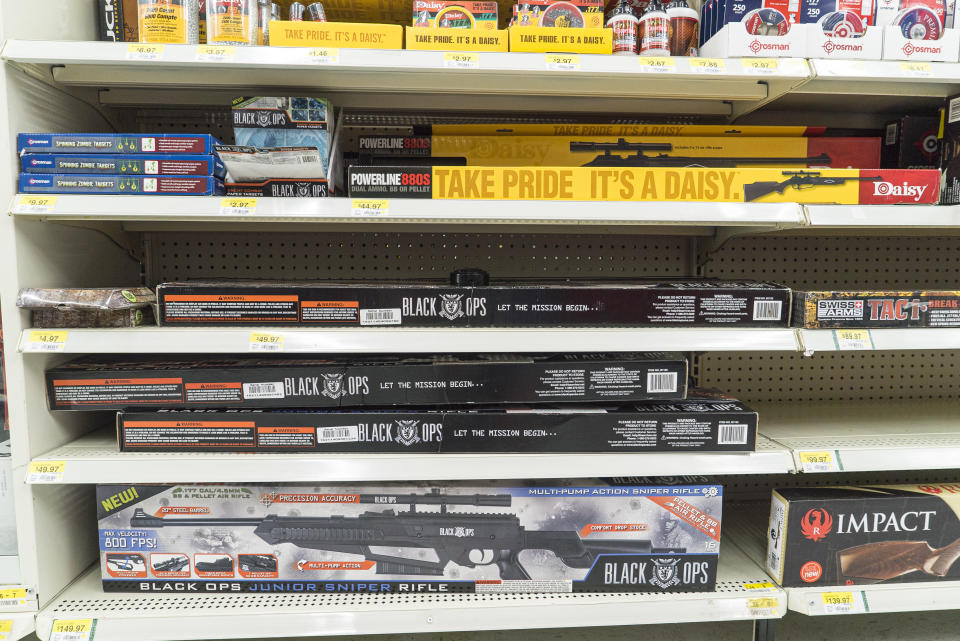 A variety of rifles seen packed on store shelves. 