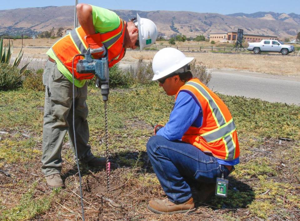 Greg Mortka, left, and Mark Nishibayashi install a passive soil gas probe near the airport fire station. Areas of the San Luis Obispo County Regional Airport were tested July 26, 2016, for TCE in an effort to determine a source of contamination.