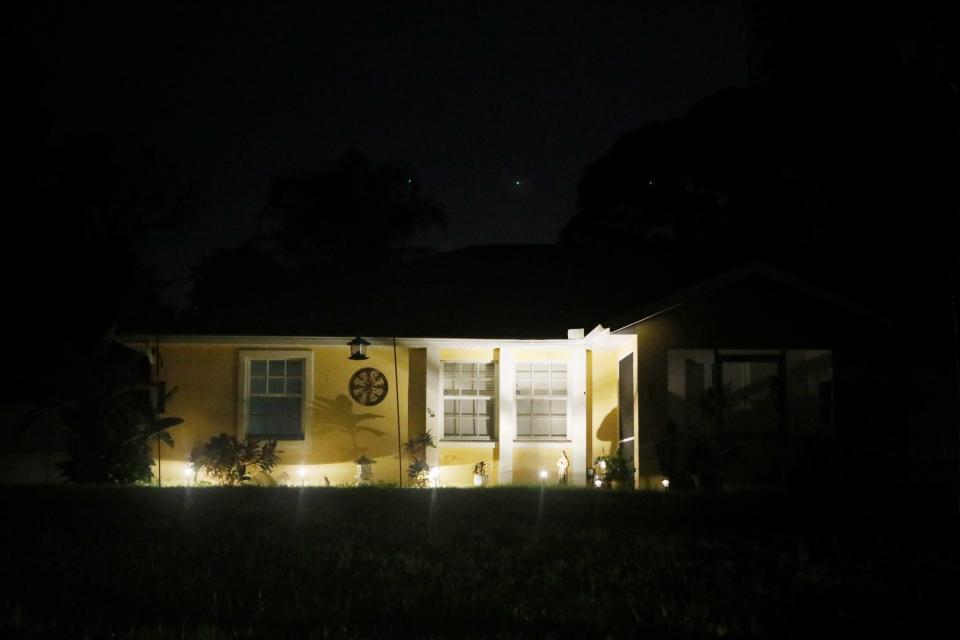 The Laundrie family home is pictured at night as officers continue their search (Getty )