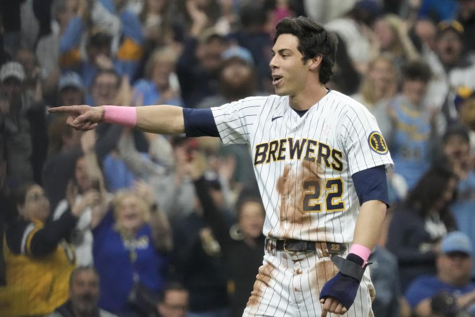 Milwaukee Brewers' Christian Yelich reacts after scoring during the third inning of a baseball game against the Kansas City Royals Sunday, May 14, 2023, in Milwaukee. (AP Photo/Morry Gash)