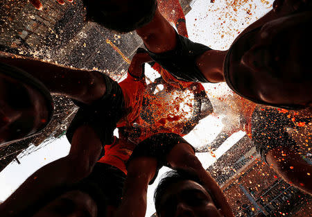 A devotee breaks a clay pot containing curd as others form a human pyramid during celebrations to mark the Hindu festival of Janmashtami in Mumbai, India August 25, 2016. REUTERS/Danish Siddiqui