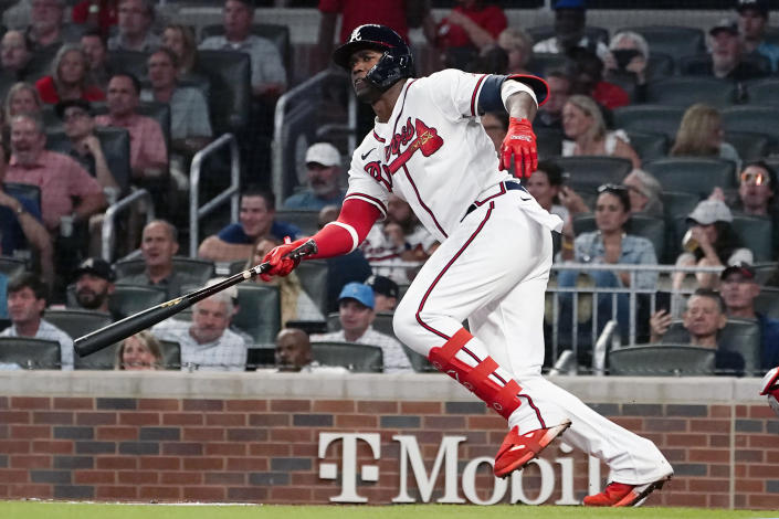 Atlanta Braves' Jorge Soler (12) drives in two runs with a base hit in the third inning of a baseball game against the Philadelphia Phillies Tuesday, Sept. 28, 2021, in Atlanta. (AP Photo/John Bazemore)