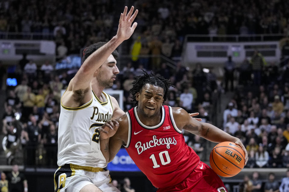 Ohio State forward Brice Sensabaugh (10) drives on Purdue guard Ethan Morton (25) in the first half of an NCAA college basketball game in West Lafayette, Ind., Sunday, Feb. 19, 2023. (AP Photo/Michael Conroy)