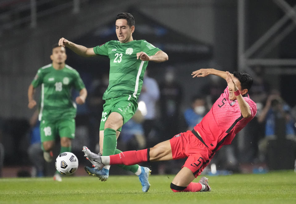 South Korea's Jung Woo-young, right, fights for the ball against Turkmenistan's Velmyrat Ballakov during their Asian zone Group H qualifying soccer match for the FIFA World Cup Qatar 2022 at Goyang stadium in Goyang, South Korea, Saturday, June 5, 2021. (AP Photo/Lee Jin-man)