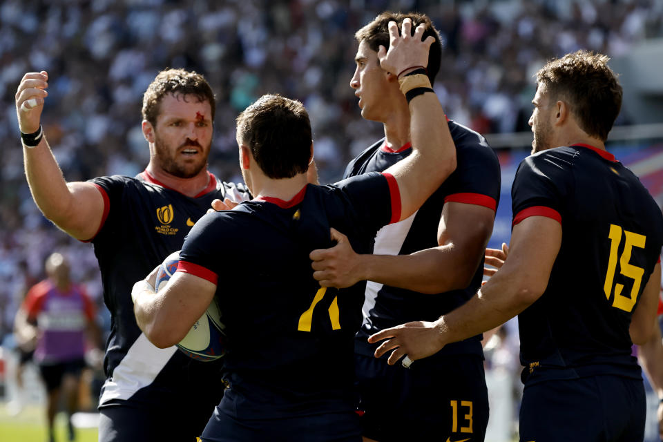 Argentina's Mateo Carreras, centre, celebrates with teammates after scoring a try during the Rugby World Cup Pool D match between Japan and Argentina, at the Stade de la Beaujoire in Nantes, France, Sunday, Oct. 8, 2023. (AP Photo/Jeremias Gonzalez)