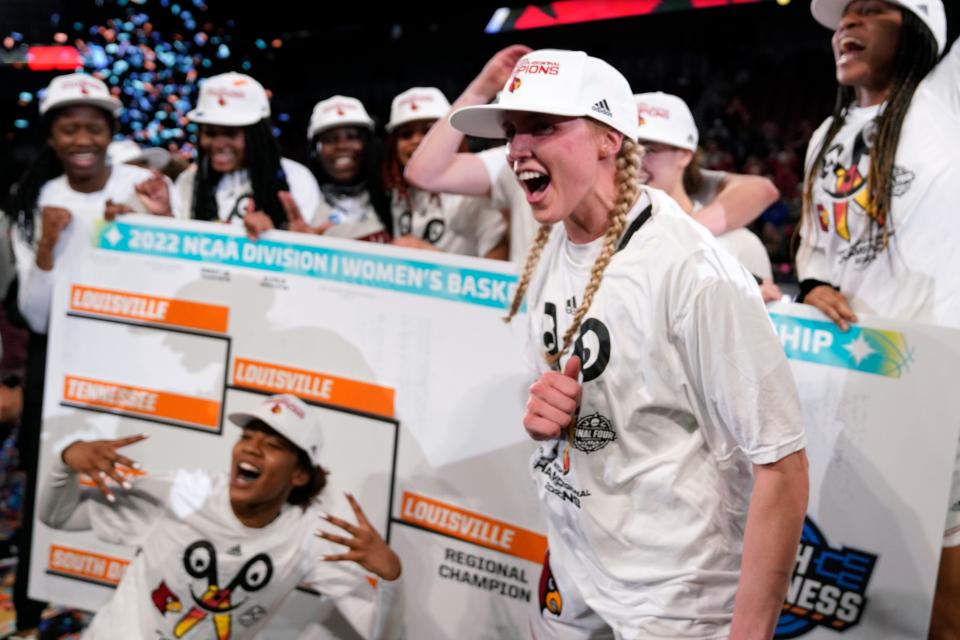 Hailey Van Lith, foreground, celebrates after beating Michigan 62-50 in a college basketball game in the Elite 8 round of the 2022vNCAA women's tournament.