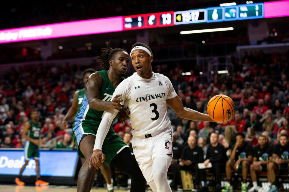 Cincinnati Bearcats guard Mika Adams-Woods (3) passes the ball during the first half of an NCAA men’s college basketball game on Thursday, Dec. 29, 2022, at Fifth Third Arena in Cincinnati. The Bearcats defeated the Green Wave 88-77 with a crowd of 9,484.