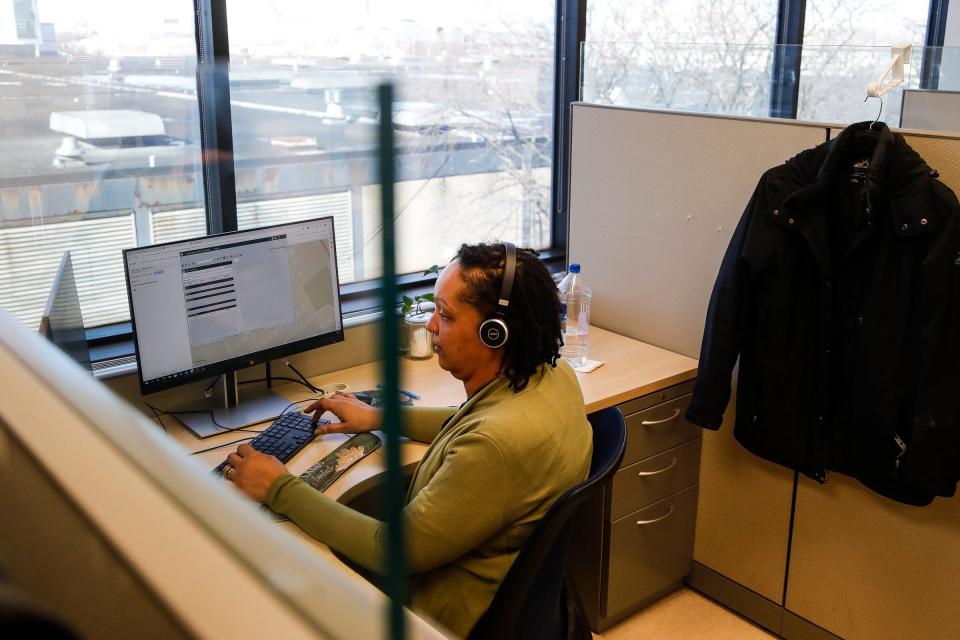 Customer service representative Coral Ellington works at scheduling and dispatching paratransit for clients from the call center at the DDOT Administrative Building in Detroit on Feb. 28, 2023.