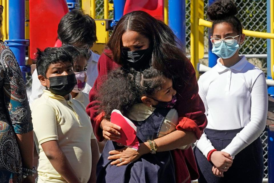 Duchess Meghan is hugged by a student during a visit to P.S. 123, the Mahalia Jackson School, in New York's Harlem neighborhood on Sept. 24, 2021.