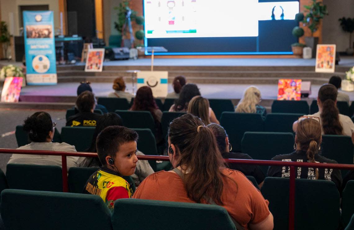 Olga Flores and her son Isaac, 7, a Sacramento City Unified School District student, attend a Sacramento ACT town hall meeting focused on community schools at South Sacramento Christian Center on April 12. Lezlie Sterling/lsterling@sacbee.com