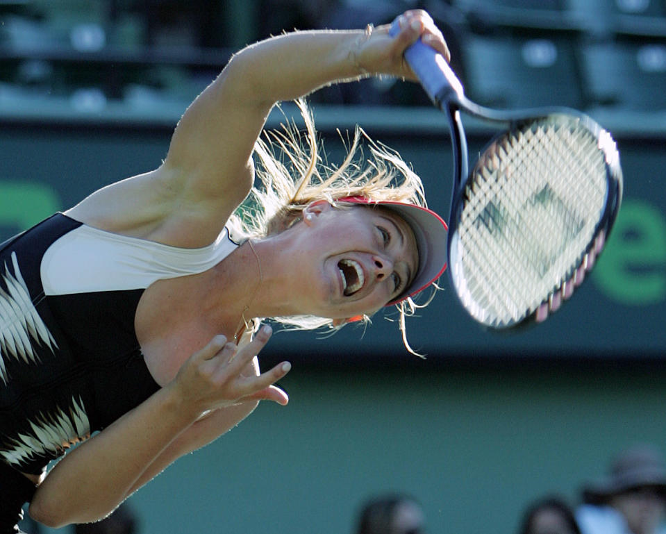 FILE - In this March 26, 2006, file photo, Maria Sharapova of Russia serves to Maria Elena Camerin of Italy at the Nasdaq-100 Open tennis tournament in Key Biscayne, Fla. Sharapova quietly walked away from tennis at the age of 32 on Wednesday, Feb. 26, 2020, ending a career that featured five Grand Slam titles, time at No. 1 in the WTA rankings and a 15-month doping ban. (AP Photo/Wilfredo Lee, File)