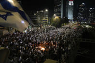 Israelis opposed to Prime Minister Benjamin Netanyahu's judicial overhaul plan set up bonfires and block a highway during a protest moments after the Israeli leader fired his defense minister, in Tel Aviv, Israel, Sunday, March 26, 2023. Defense Minister Yoav Gallant had called on Netanyahu to freeze the plan, citing deep divisions in the country and turmoil in the military. (AP Photo/Ohad Zwigenberg)