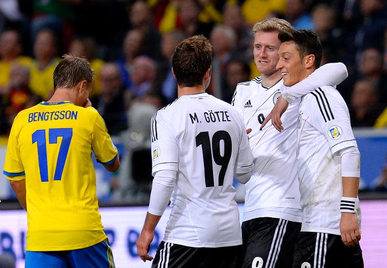 Andre Schurrle (2nd right) celebrates with his teammates after scoring during Germany's World Cup qualifier against Sweden in Solna, Sweden on October 15, 2013