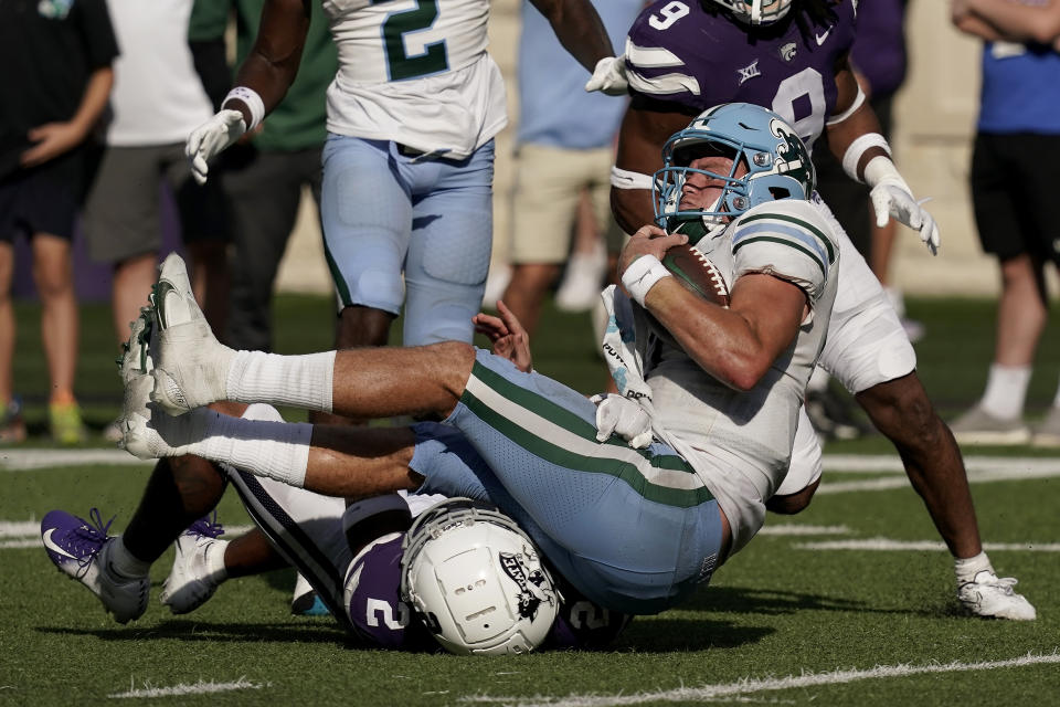 Tulane quarterback Michael Pratt is tackled by Kansas State safety Kobe Savage (2) after running for a for a first down during the second half of an NCAA college football game Saturday, Sept. 17, 2022, in Manhattan, Kan. Tulane won 17-10. (AP Photo/Charlie Riedel)