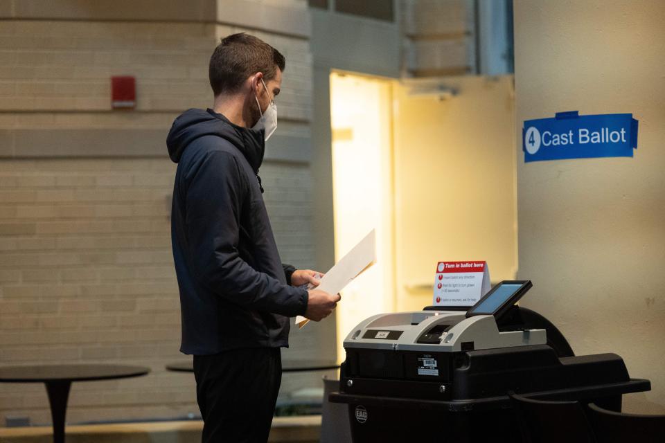 A voter prepares to cast his ballot during the midterm elections at a polling station in Arlington, Va. 