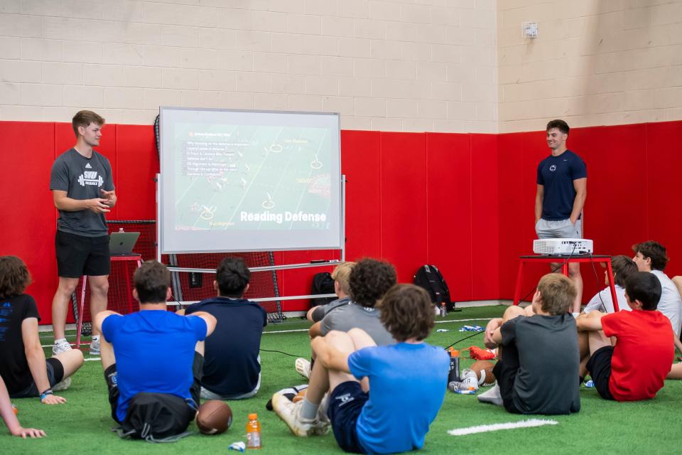 Cade Pribula (left) and Beau Pribula (right) smile as they talk about reading defenses during a classroom session at the Pribula Brothers' Quarterback Camp at Cumberland Valley High School May 21, 2023, in Mechanicsburg.