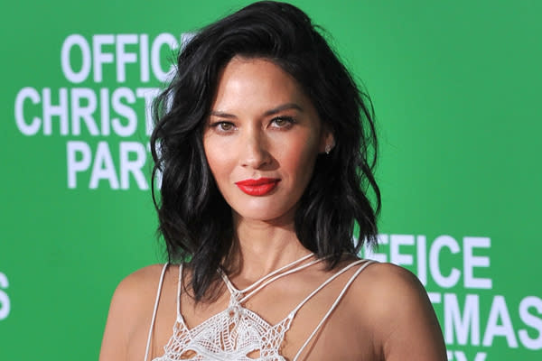 Olivia Munn’s beer pong skills and sassy one-piece suit are giving us major college flashbacks