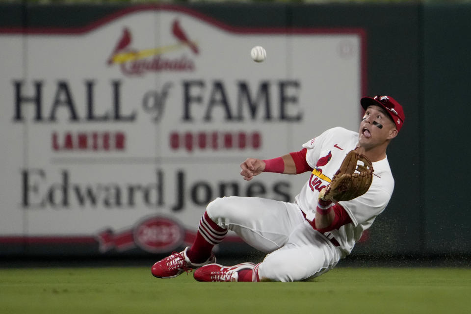 St. Louis Cardinals center fielder Lars Nootbaar slides and catches a fly ball Oakland Athletics' Zack Gelof for an out during the sixth inning of a baseball game Tuesday, Aug. 15, 2023, in St. Louis. (AP Photo/Jeff Roberson)