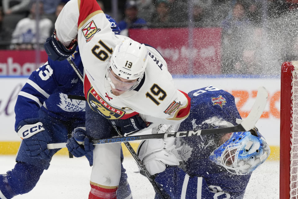 Florida Panthers left wing Matthew Tkachuk (19) crashes into Toronto Maple Leafs goaltender Joseph Woll as Leafs' Matthew Knies defends during the third period of an NHL hockey game in Toronto on Tuesday, Nov. 28, 2023. (Frank Gunn/The Canadian Press via AP)