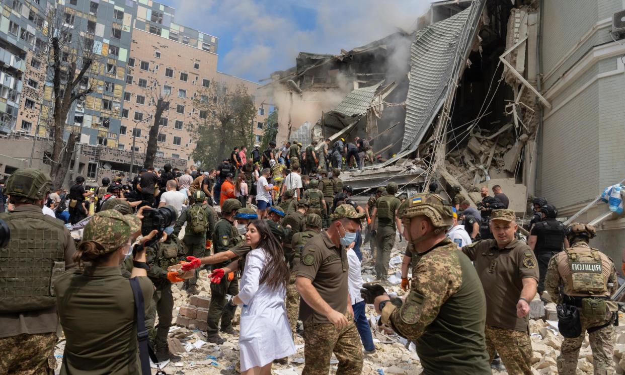 <span>Rescuers, volunteers and medical workers search for survivors after a Russian missile attack on Ukraine’s biggest children’s hospital.</span><span>Photograph: Efrem Lukatsky/AP</span>