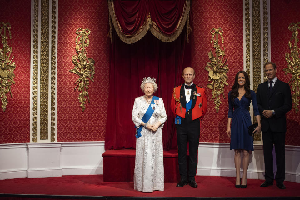 The empty space after the figures of Britain's Prince Harry and Meghan, Duchess of Sussex, were removed next to Queen Elizabeth II, Prince Philip and Prince William and Kate, Duchess of Cambridge, at Madame Tussauds in London, Thursday Jan. 9, 2020. Madame Tussauds moved its figures of Prince Harry and Meghan, Duchess of Sussex from its Royal Family set to elsewhere in the attraction. (Victoria Jones/PA via AP)