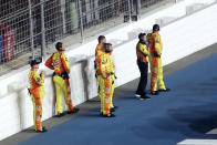 Ryan Newman's crew stands near a wall on pit road as they are kept back from rescue workers that are aiding Newman after he was involved in a crash on the final lap of the NASCAR Daytona 500 auto race at Daytona International Speedway, Monday, Feb. 17, 2020, in Daytona Beach, Fla. Sunday's race was postponed because of rain. (AP Photo/David Graham)