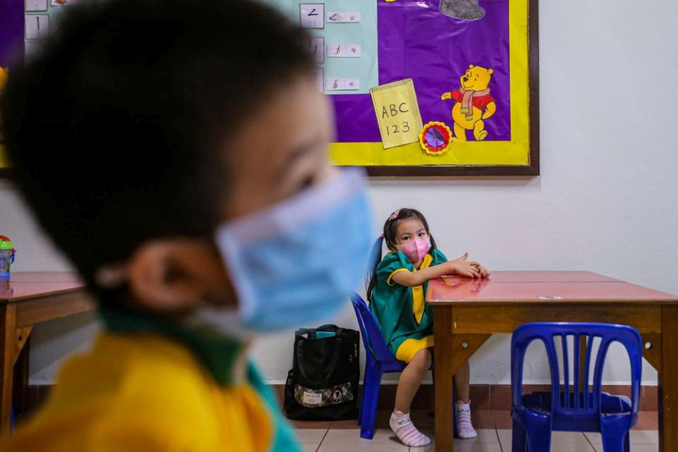 Preschoolers are seated accordingly to maintain social distancing while a teacher conducts a class at Mayter Kindergarten in Cheras July 1, 2020. — Picture by Hari Anggara