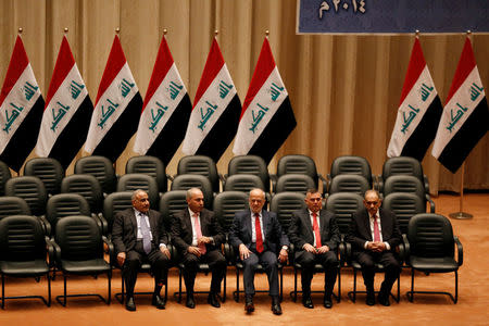 FILE PHOTO: (L to R) Iraq's new ministers, Oil minister Adel Abdel Mehdi, Planning minister Salman Ali Al Jumaily, Foreign minister Ibrahim Jafaari and Iraq's new deputy prime ministers Baha Araji and Saleh Mutlaq sit during a parliamentary session to vote on Iraq's new government at the parliament headquarters, in Baghdad, Iraq, September 8, 2014. REUTERS/Thaier Al-Sudani/File Photo