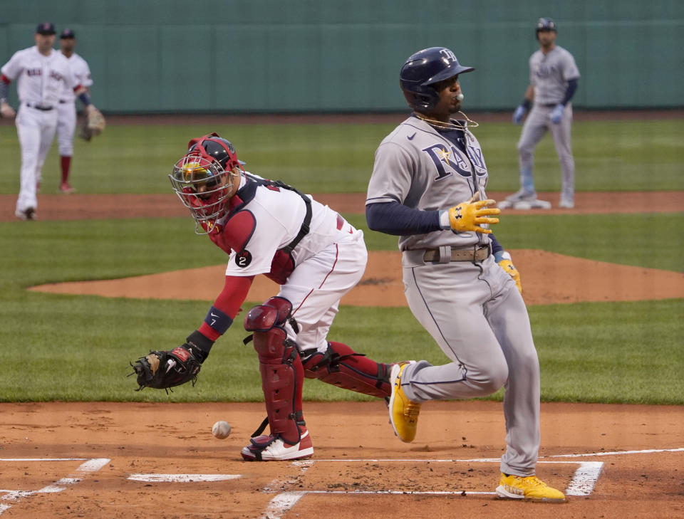 Tampa Bay Rays' Wander Franco scores ahead of the throw to Boston Red Sox catcher Christian Vazquez on a double by Kevin Kiermaier during the first inning of a baseball game at Fenway Park, Tuesday, July 5, 2022, in Boston. (AP Photo/Mary Schwalm)