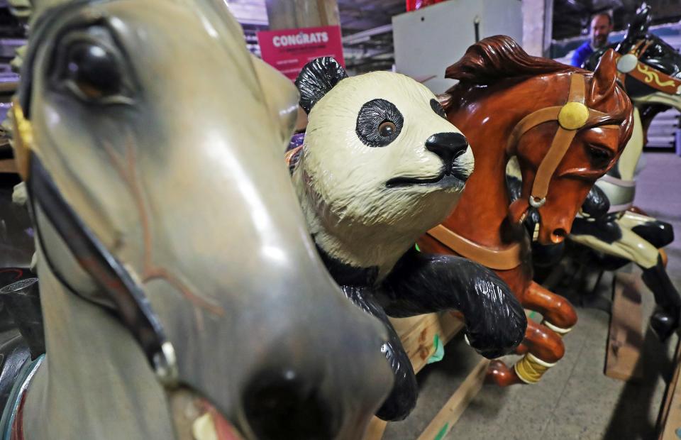 Animals from the carousel that was once in Chapel Hill Mall, including horses and pandas, now sit in storage in the former O'Neil's building.