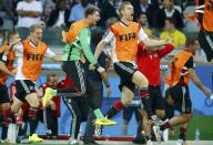 Germany's substitute goalkeeper Ron-Robert Zieler (in green) and his teammates celebrate after Toni Kroos (unseen) scored the team's third goal during their 2014 World Cup semi-finals against Brazil at the Mineirao stadium in Belo Horizonte July 8, 2014. REUTERS/Ruben Sprich