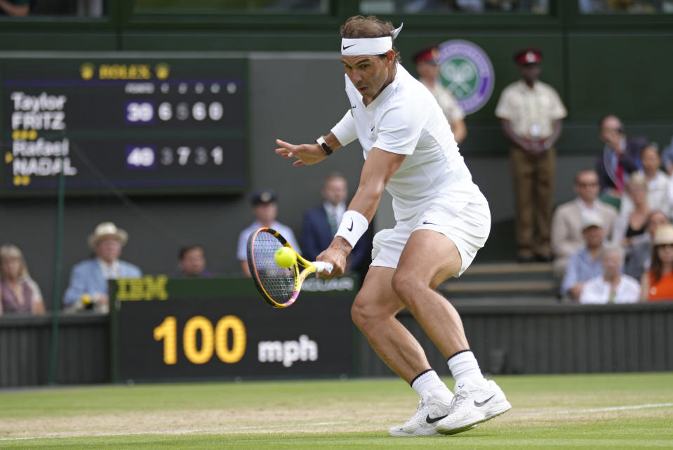 Spain's Rafael Nadal returns to Taylor Fritz of the US in a men's singles quarterfinal match on day ten of the Wimbledon tennis championships in London, Wednesday, July 6, 2022. (AP Photo/Kirsty Wigglesworth)