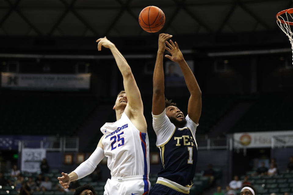 Boise State center Robin Jorch (25) and Georgia Tech forward James Banks III (1) fight for a rebound during the first half of an NCAA college basketball game Sunday, Dec. 22, 2019, in Honolulu. (AP Photo/Marco Garcia)