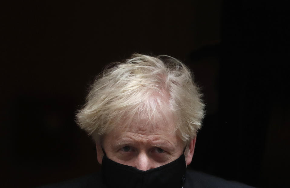 FILE - Britain's Prime Minister Boris Johnson leaves 10 Downing Street to attend the weekly Prime Ministers' Questions session at parliament in London, Wednesday, Dec. 9, 2020. (AP Photo/Frank Augstein, File)